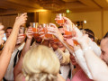wedding guests clinking glasses together